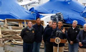 U.S. President Barack Obama (3rd R) speaks in a neighborhood after he tours damage done by Hurricane Sandy in Brigantine, New Jersey, October 31, 2012. New Jersey Governor Chris Christie stands behind Obama. Putting aside partisan differences, Obama and Christie toured storm-stricken parts of New Jersey together on Wednesday, taking in scenes of flooded roads and burning homes in the aftermath of superstorm Sandy. REUTERS/Larry Downing 